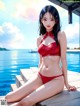 A woman in a red bikini sitting on a dock by the water.